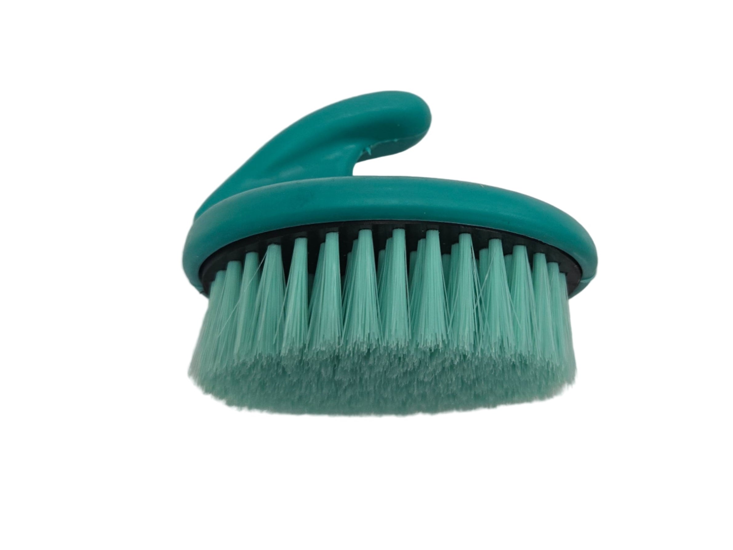 Green scrub brush on a white surface